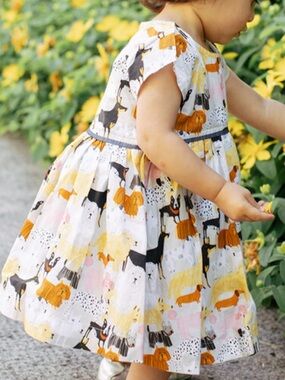 Pink Chicken Girls Fatima Dress features a playful dog park print